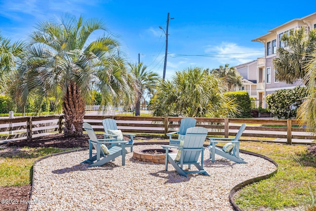 view of yard featuring fence and an outdoor fire pit