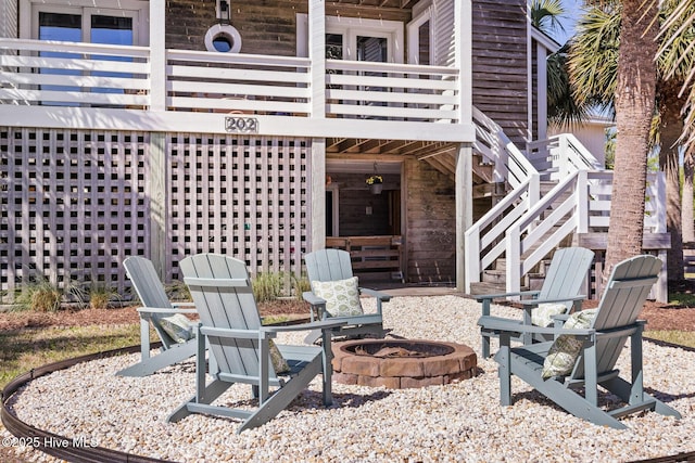 view of patio / terrace with stairs and an outdoor fire pit