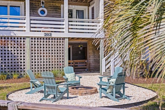view of patio featuring stairway and a fire pit