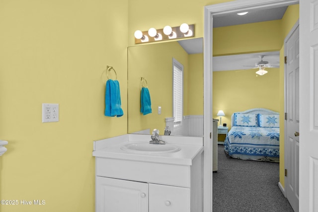 bathroom featuring ceiling fan, ensuite bath, and vanity