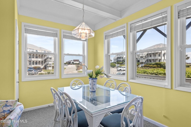 dining room with baseboards, beamed ceiling, a notable chandelier, and carpet