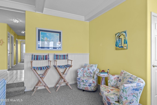 sitting room featuring carpet and ornamental molding