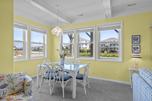 dining space featuring baseboards, beamed ceiling, and carpet floors