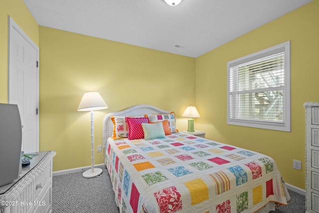 bedroom with carpet, visible vents, and baseboards