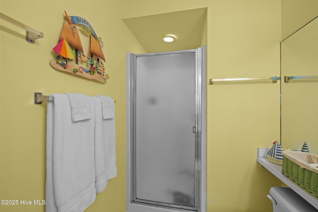 full bath with toilet and a shower stall