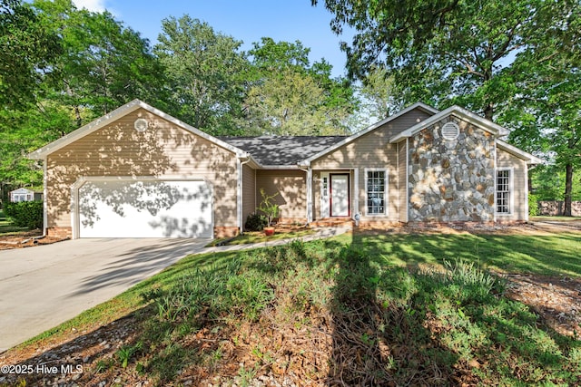 view of front of house featuring driveway, a front lawn, and an attached garage