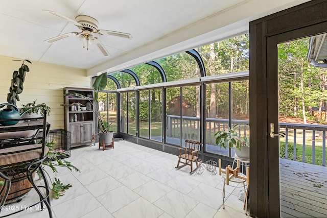 sunroom with a healthy amount of sunlight and a ceiling fan