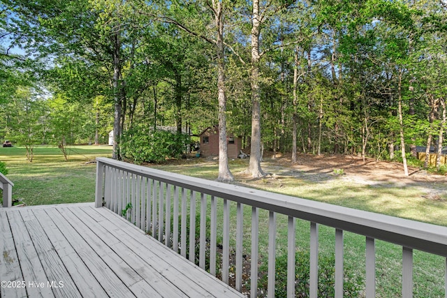 deck featuring an outbuilding and a lawn