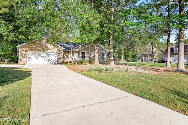 ranch-style house with concrete driveway, a front yard, and an attached garage