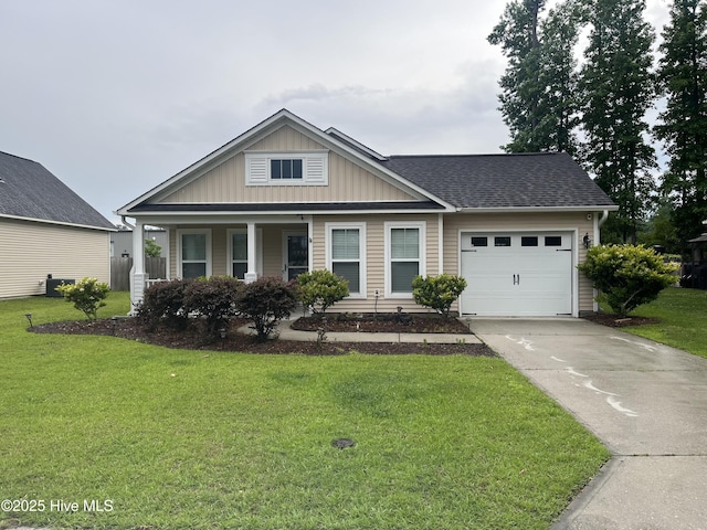 1202 Mill Creek Loop, Leland, NC 28451 - view of front of house featuring a garage, board and batten siding, concrete driveway, a front lawn, and a shingled roof