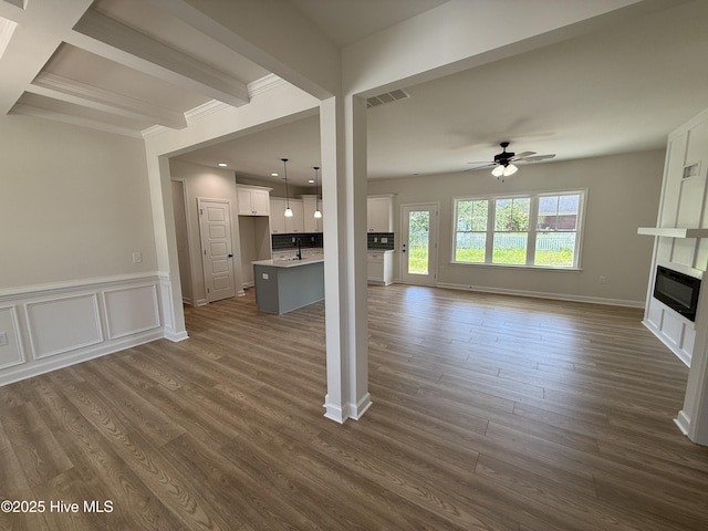 1104 Margaret Ln, Kinston, NC 28501 - unfurnished living room with a ceiling fan, a large fireplace, dark wood-style flooring, beamed ceiling, and recessed lighting
