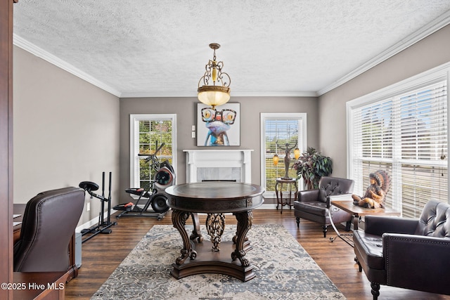 home office featuring a fireplace, crown molding, baseboards, a textured ceiling, and dark wood finished floors