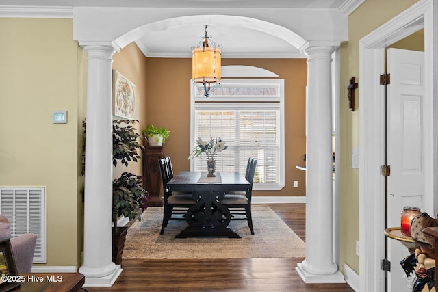 dining area with arched walkways, visible vents, wood finished floors, and ornate columns