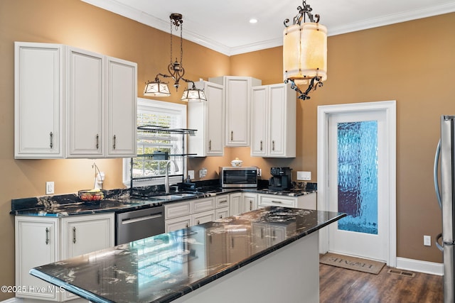 kitchen with a sink, dark wood-style flooring, visible vents, white cabinetry, and appliances with stainless steel finishes