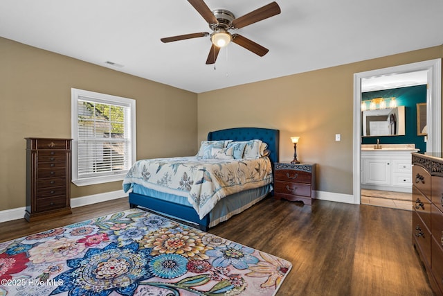 bedroom with a sink, visible vents, baseboards, wood finished floors, and a ceiling fan