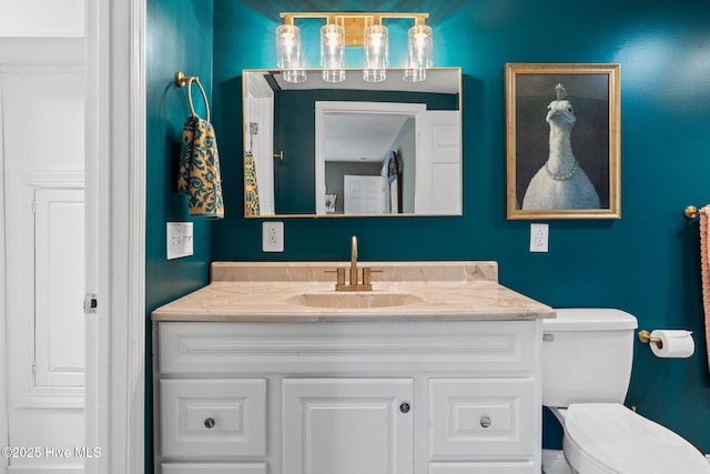 bathroom featuring toilet and vanity
