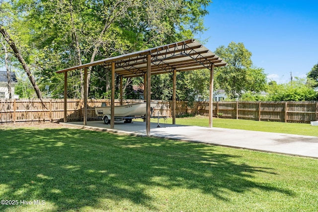 view of yard with fence and a detached carport