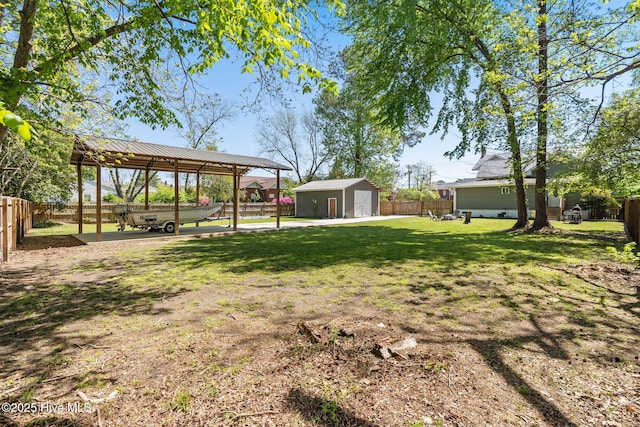 view of yard featuring a storage shed, an outbuilding, and a fenced backyard