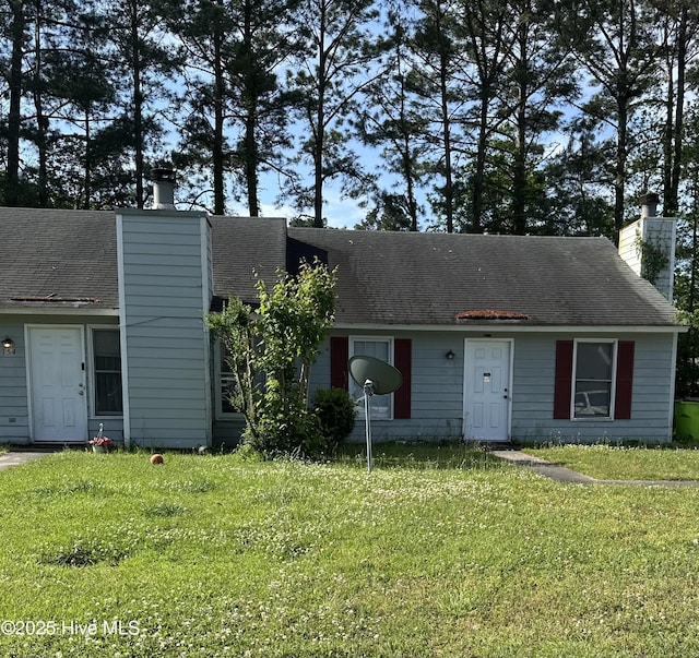 view of front of property featuring a front yard and a chimney