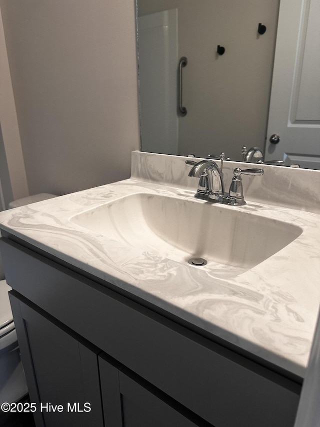 bathroom featuring toilet and vanity