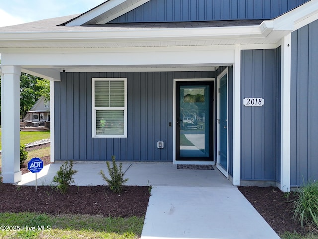 entrance to property with a porch and board and batten siding