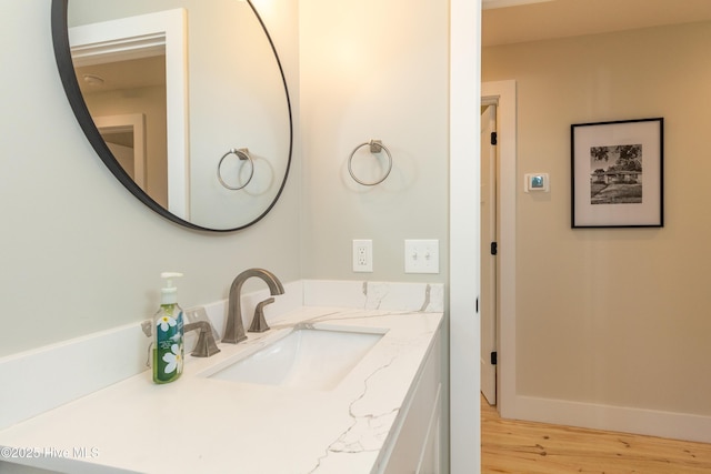 bathroom with wood finished floors and vanity