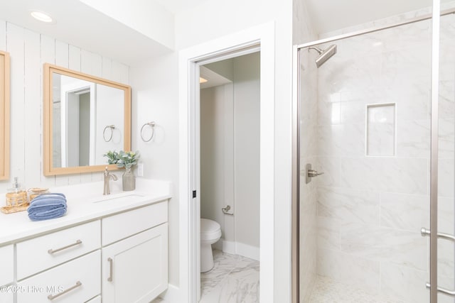 full bathroom featuring vanity, toilet, a shower stall, and marble finish floor