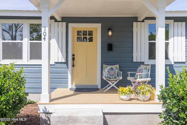 view of exterior entry featuring covered porch