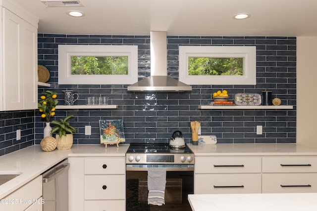 kitchen with white cabinetry, tasteful backsplash, stainless steel appliances, light countertops, and wall chimney exhaust hood