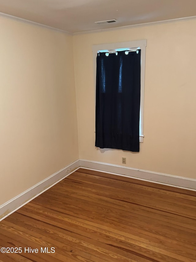 207 E Ashe St, Burgaw, NC 28425 - unfurnished room featuring ornamental molding, visible vents, wood finished floors, and baseboards