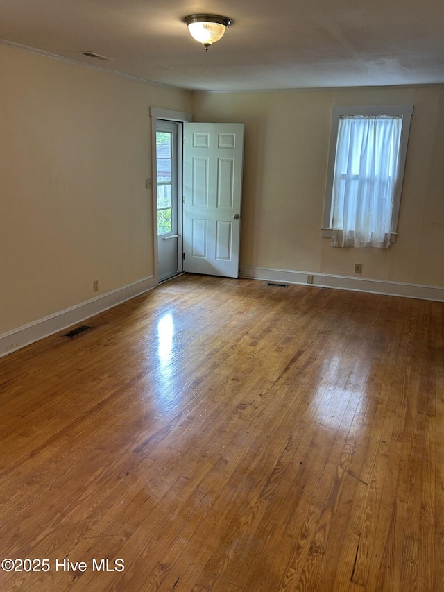 207 E Ashe St, Burgaw, NC 28425 - spare room with visible vents, wood finished floors, and baseboards