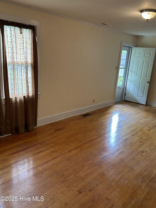 207 E Ashe St, Burgaw, NC 28425 - spare room with crown molding, visible vents, wood finished floors, and baseboards