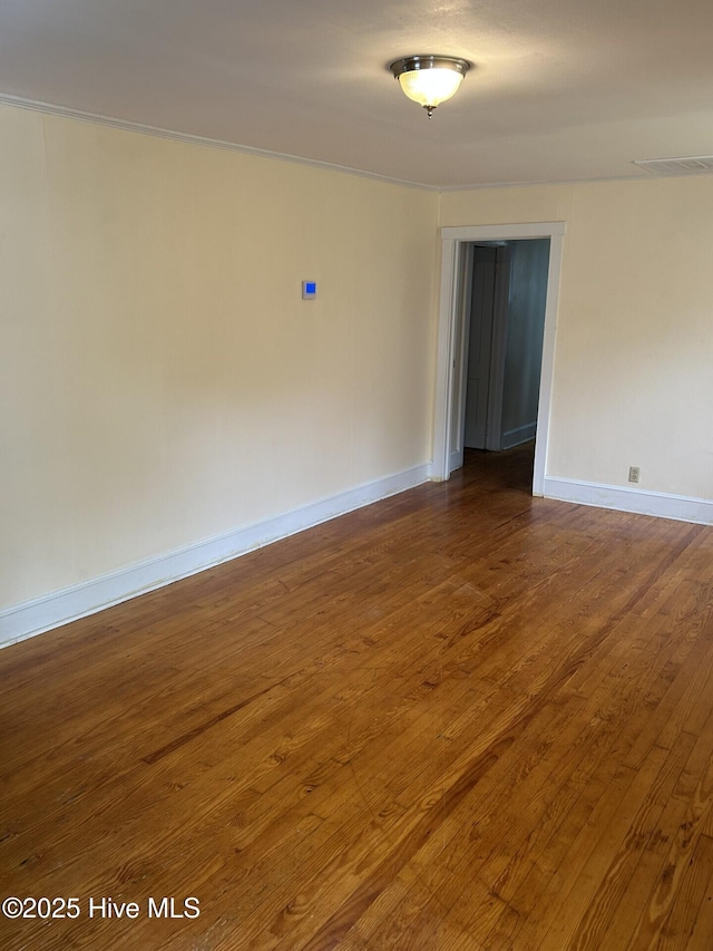 207 E Ashe St, Burgaw, NC 28425 - empty room featuring visible vents, wood finished floors, and baseboards