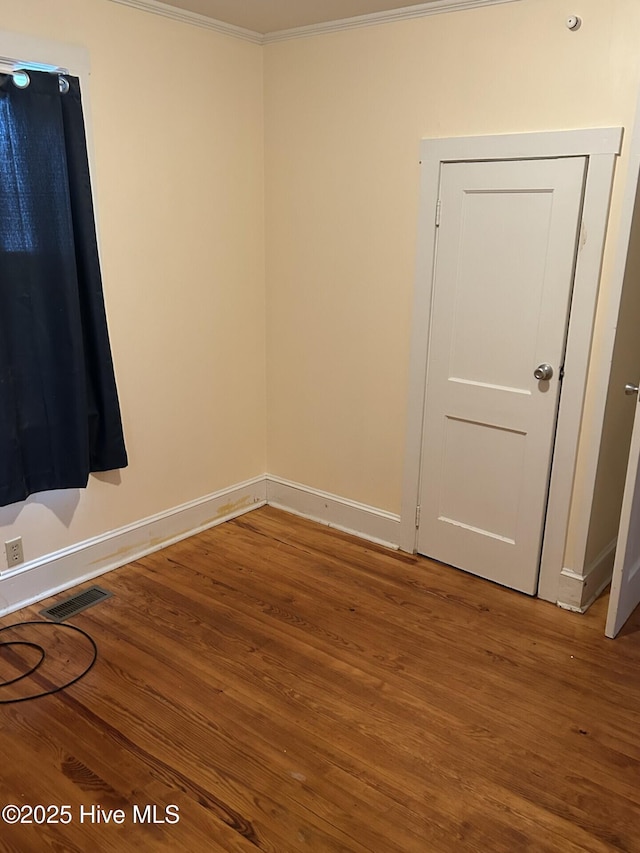 207 E Ashe St, Burgaw, NC 28425 - spare room featuring baseboards, visible vents, ornamental molding, and wood finished floors