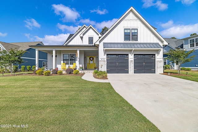 view of front facade featuring board and batten siding, driveway, a front yard, and a garage