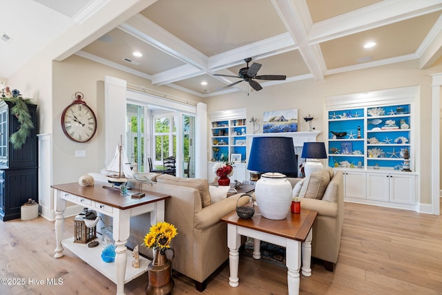 living area with coffered ceiling, a ceiling fan, light wood finished floors, beamed ceiling, and ornamental molding