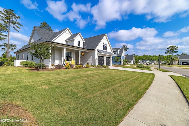 view of front facade featuring concrete driveway, an attached garage, covered porch, a front lawn, and board and batten siding