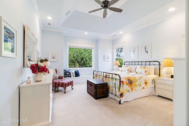 bedroom featuring carpet floors, crown molding, a tray ceiling, recessed lighting, and ceiling fan