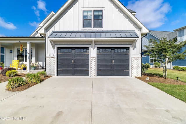 modern inspired farmhouse with board and batten siding, brick siding, a standing seam roof, and concrete driveway