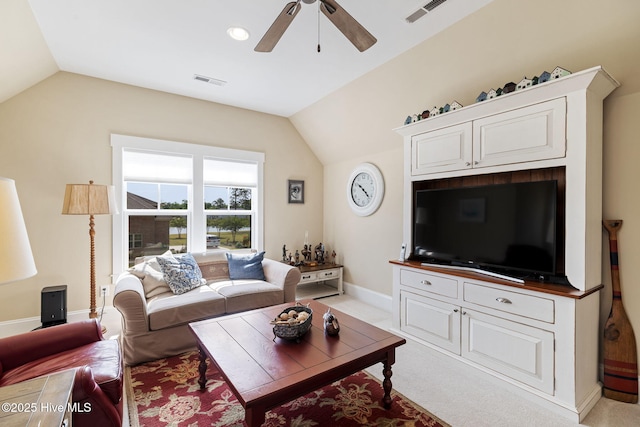 living area featuring vaulted ceiling, ceiling fan, baseboards, and light carpet