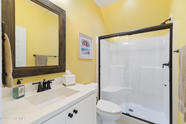 full bathroom with a stall shower, toilet, and vanity