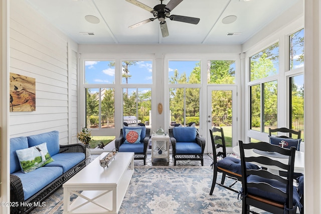 sunroom featuring french doors and wooden walls