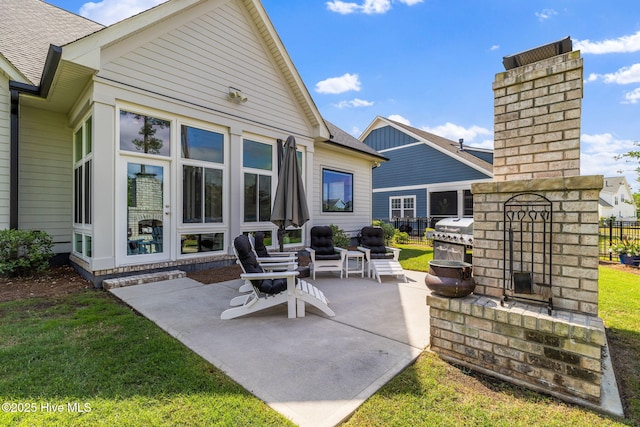 view of patio with grilling area and a fireplace
