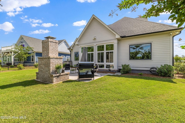 rear view of property with a patio area, a shingled roof, and a chimney