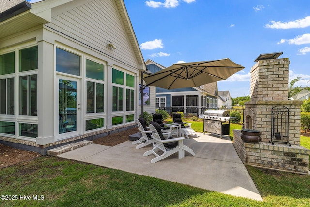 view of patio / terrace featuring a grill and a brick fireplace