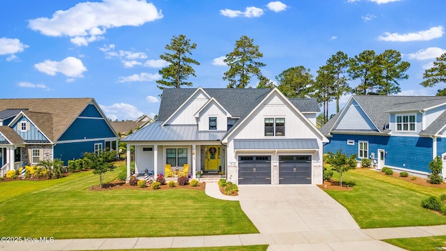 modern inspired farmhouse featuring board and batten siding, a porch, a standing seam roof, driveway, and a front lawn