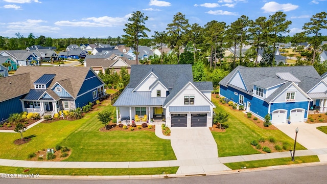 view of front of house featuring concrete driveway, a residential view, board and batten siding, covered porch, and a front lawn