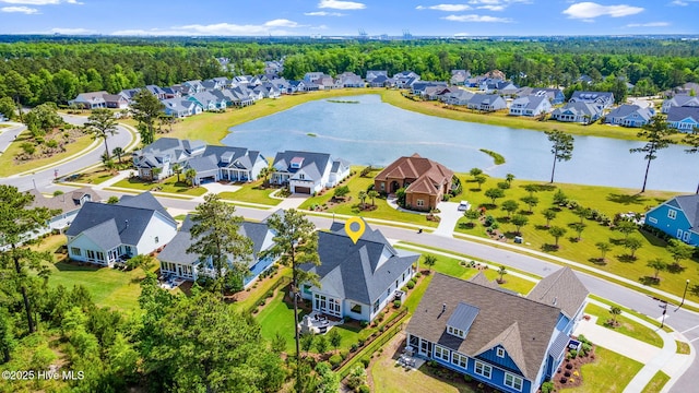 aerial view of residential area featuring a nearby body of water