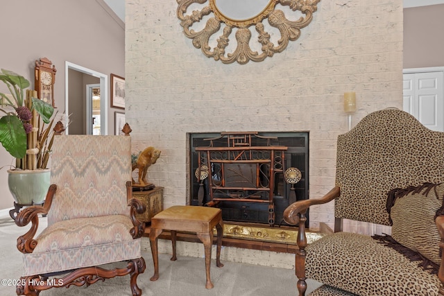 living area with carpet floors and a brick fireplace