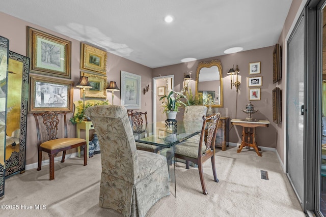 dining space with carpet and baseboards